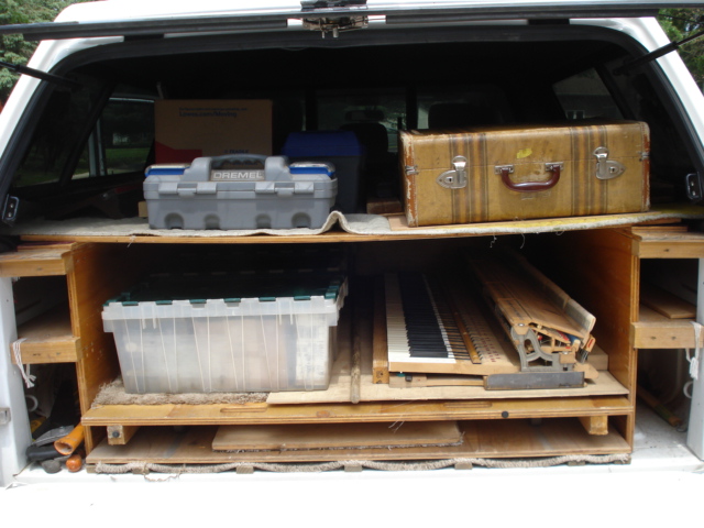 26 - Action, pedal lyre, parts, regulating table loaded into truck